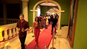 People walking on a red carpet at an event.