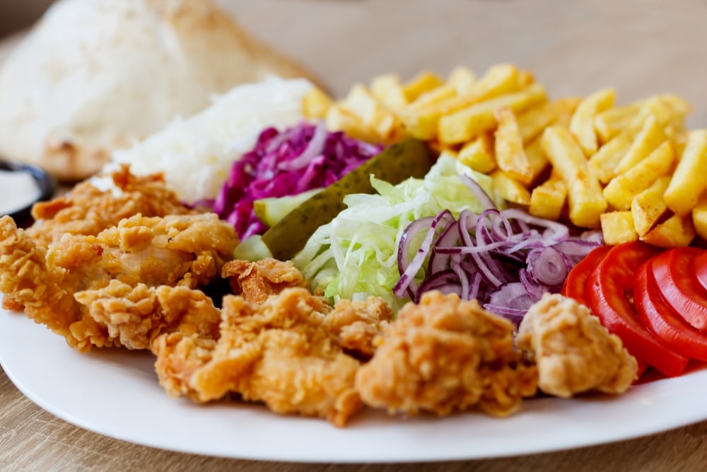 Fried chicken plate with fries and salad.