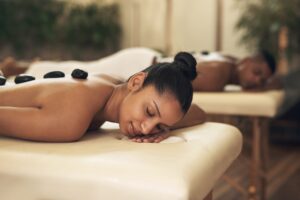 Couple enjoying hot stone massage.